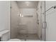 Modern bathroom with a frameless glass shower, tiled walls, and recessed niche at 3304 Cheswick Dr, Raleigh, NC 27609