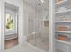 Beautiful bathroom with glass shower, dual shower heads, bench, and convenient built-in storage shelves at 3304 Cheswick Dr, Raleigh, NC 27609
