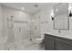Modern bathroom with glass-enclosed shower, bench, and sleek vanity at 3304 Cheswick Dr, Raleigh, NC 27609