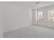 Bright bedroom with two windows, plush carpet, and neutral wall color at 3304 Cheswick Dr, Raleigh, NC 27609
