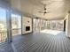 Expansive outdoor deck area featuring a fireplace and ceiling fans, perfect for entertaining at 3304 Cheswick Dr, Raleigh, NC 27609