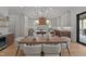 Elegant dining room featuring a wooden table, chandelier, and a view into the modern kitchen with a large island at 3304 Cheswick Dr, Raleigh, NC 27609