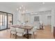 Open dining area with a modern chandelier, dining table, and view into living room at 3304 Cheswick Dr, Raleigh, NC 27609