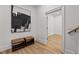 Inviting entryway showcasing wood floors and a stylish bench at 3304 Cheswick Dr, Raleigh, NC 27609