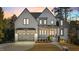 Exterior of two-story home with white brick, arched front door, and attached garage at 3304 Cheswick Dr, Raleigh, NC 27609