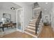The foyer features a staircase, a view of the office, and is well-lit with pot lights at 3304 Cheswick Dr, Raleigh, NC 27609