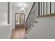 The foyer features a wooden door and stairs, with an elegant chandelier at 3304 Cheswick Dr, Raleigh, NC 27609