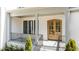 Covered front porch featuring brick columns, wood door, and iron railing at 3304 Cheswick Dr, Raleigh, NC 27609
