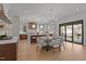 Bright, open kitchen and dining area with stainless steel appliances, island, and hardwood floors at 3304 Cheswick Dr, Raleigh, NC 27609