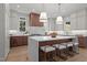 Spacious kitchen featuring an island with seating, modern appliances, two pendant lights, and ample cabinet space at 3304 Cheswick Dr, Raleigh, NC 27609
