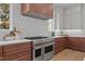 Gourmet kitchen featuring stainless steel appliances, a copper range hood and white subway tile at 3304 Cheswick Dr, Raleigh, NC 27609