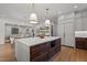 Modern kitchen with a large island featuring quartz countertops, stainless steel microwave, and open concept living at 3304 Cheswick Dr, Raleigh, NC 27609