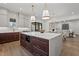 Modern kitchen with a large island featuring quartz countertops, stainless steel appliances, and open concept living at 3304 Cheswick Dr, Raleigh, NC 27609