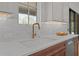 Close up of kitchen sink and faucet, counter, and backsplash tile at 3304 Cheswick Dr, Raleigh, NC 27609