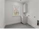 Clean and functional laundry room with utility sink and window at 3304 Cheswick Dr, Raleigh, NC 27609
