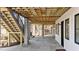 Covered outdoor patio featuring stone flooring, fireplace, wood ceiling, stairs, and white siding at 3304 Cheswick Dr, Raleigh, NC 27609