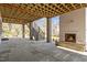 Covered outdoor patio with stone flooring, fireplace, wood ceiling, and stairs to backyard at 3304 Cheswick Dr, Raleigh, NC 27609