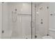 Modern glass walk-in shower featuring dual shower heads, bench and built-in shelf at 3304 Cheswick Dr, Raleigh, NC 27609