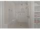 Sleek walk-in shower featuring multiple showerheads, a built-in bench, and elegant tile work at 3304 Cheswick Dr, Raleigh, NC 27609