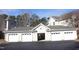 Three-car garage with white doors and parking at 331 Providence Glen Dr, Chapel Hill, NC 27514