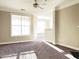 Spacious living room with large windows and ceiling fan at 331 Providence Glen Dr, Chapel Hill, NC 27514