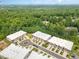 Aerial view of townhome community situated in a lush, wooded setting at 4015 Southpoint Lndg Way, Durham, NC 27707