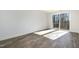 Bright bedroom with wood-look floors and sliding glass door to balcony at 4015 Southpoint Lndg Way, Durham, NC 27707