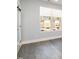 Bright room with wood-look floors, large window, and modern door at 4015 Southpoint Lndg Way, Durham, NC 27707