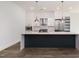 Modern kitchen with large island, stainless steel appliances, and white cabinets at 4015 Southpoint Lndg Way, Durham, NC 27707