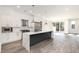 Modern kitchen with large island, stainless steel appliances, and white cabinets at 4015 Southpoint Lndg Way, Durham, NC 27707