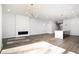 Open living room with hardwood floors and modern fireplace at 4015 Southpoint Lndg Way, Durham, NC 27707
