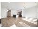 Open living room and kitchen with hardwood floors and modern light fixtures at 4015 Southpoint Lndg Way, Durham, NC 27707