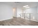 Upper level landing with wood-look floors and modern railing at 4015 Southpoint Lndg Way, Durham, NC 27707