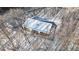Aerial view of a modern home with snow covered trees and a wooded surrounding landscape at 6358 Pathway Ct Ct, Chapel Hill, NC 27516