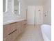 Bathroom featuring modern double vanity with walk-in shower, soaking tub, and terrazzo flooring at 6358 Pathway Ct Ct, Chapel Hill, NC 27516