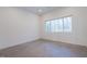 Bright bedroom featuring modern concrete flooring and a large window view at 6358 Pathway Ct Ct, Chapel Hill, NC 27516