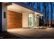 Modern home exterior with a prominent wood accent wall, minimalist design, and ample driveway space at 6358 Pathway Ct Ct, Chapel Hill, NC 27516