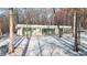 Modern single-story home featuring walls of glass, surrounded by wooded landscape and snow at 6358 Pathway Ct Ct, Chapel Hill, NC 27516