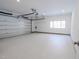 Spacious garage with a roll-up door and epoxy flooring providing ample room for parking at 6358 Pathway Ct Ct, Chapel Hill, NC 27516