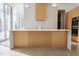 Modern kitchen island with white countertops, light wood accents, and white tiled backsplash at 6358 Pathway Ct Ct, Chapel Hill, NC 27516