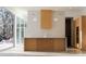 Contemporary kitchen featuring an island, custom hood, and wall oven next to a large glass window at 6358 Pathway Ct Ct, Chapel Hill, NC 27516