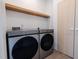 Convenient laundry room featuring a modern washer and dryer, with storage space above at 6358 Pathway Ct Ct, Chapel Hill, NC 27516