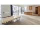 Spacious living room with sleek concrete floors, modern furniture, fireplace, and large glass windows at 6358 Pathway Ct Ct, Chapel Hill, NC 27516