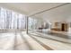 Bright and airy living room featuring floor to ceiling windows, fireplace and concrete floors at 6358 Pathway Ct Ct, Chapel Hill, NC 27516