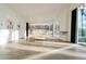Bright, spacious living room with large windows, concrete floors, and minimalist decor, showcasing modern design at 6358 Pathway Ct Ct, Chapel Hill, NC 27516