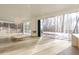 Bright living room featuring walls of windows and a modern fireplace offering views of the snowy landscape at 6358 Pathway Ct Ct, Chapel Hill, NC 27516