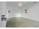 Minimalist living area with sleek concrete floors, white walls, built in shelving and modern light fixtures at 6358 Pathway Ct Ct, Chapel Hill, NC 27516
