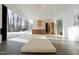 Open-concept living room and kitchen with large windows, sleek concrete floors, and modern design elements at 6358 Pathway Ct Ct, Chapel Hill, NC 27516