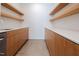 Modern pantry with light wood cabinets, open shelving, white quartz countertops, and stainless steel appliances at 6358 Pathway Ct Ct, Chapel Hill, NC 27516