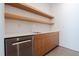 Clean pantry featuring open wood shelves, built in cabinets, and stainless steel appliances at 6358 Pathway Ct Ct, Chapel Hill, NC 27516